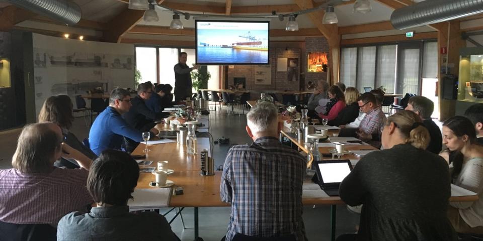 Researchers in workshop watching a maritime research presentation